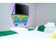 Bright bedroom with two twin beds, a fun theme, and a large TV at 4458 Kaipo Rd, Davenport, FL 33897