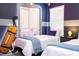 Bedroom featuring two twin beds, unique wall art, and closet at 4458 Kaipo Rd, Davenport, FL 33897