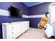 Bedroom with white dresser, a bed, and fun wall art at 4458 Kaipo Rd, Davenport, FL 33897