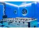 Game room with foosball table, pool table, and ocean-themed decor at 4458 Kaipo Rd, Davenport, FL 33897