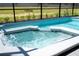 Inviting spa with bubbling water under a screened enclosure at 4458 Kaipo Rd, Davenport, FL 33897