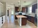 Modern kitchen with dark brown cabinets, white quartz countertops, and a large island at 2475 Hastings Blvd, Clermont, FL 34711