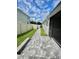 Landscaped backyard with a paved walkway at 2475 Hastings Blvd, Clermont, FL 34711