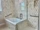 Elegant bathroom with patterned tile, a soaking tub, and glass shower enclosure at 2475 Hastings Blvd, Clermont, FL 34711