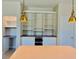 White kitchen cabinets with wood countertop and extensive shelving at 2475 Hastings Blvd, Clermont, FL 34711