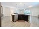 Modern kitchen island with stainless steel dishwasher and dark cabinetry at 1065 Blackwolf Run Rd, Davenport, FL 33896