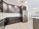 Modern kitchen with dark cabinetry and breakfast nook at 1065 Blackwolf Run Rd, Davenport, FL 33896