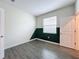 Bedroom with gray wood-look tile floor and dark green accent wall at 1065 Blackwolf Run Rd, Davenport, FL 33896