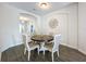 Elegant dining room with wood table and neutral colored chairs at 1065 Blackwolf Run Rd, Davenport, FL 33896