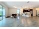 Open floor plan with living area, kitchen island, and access to covered patio at 1065 Blackwolf Run Rd, Davenport, FL 33896