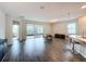 Spacious living room with wood-look tile floors and sliding glass doors to patio at 1065 Blackwolf Run Rd, Davenport, FL 33896