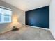 Bedroom with gray carpet, dark blue accent wall, and window at 1065 Blackwolf Run Rd, Davenport, FL 33896