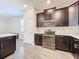 Modern kitchen with dark cabinets and stainless steel appliances at 1065 Blackwolf Run Rd, Davenport, FL 33896