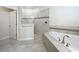 Spa-like bathroom with corner tub, walk-in shower, and tiled floors at 1065 Blackwolf Run Rd, Davenport, FL 33896