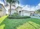 One-story house with two-car garage and landscaping at 1065 Blackwolf Run Rd, Davenport, FL 33896
