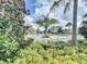 Community pool with lush landscaping and palm trees at 1065 Blackwolf Run Rd, Davenport, FL 33896