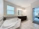 Bathroom with double vanity, soaking tub, and view to bedroom at 1065 Blackwolf Run Rd, Davenport, FL 33896