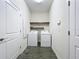 Convenient laundry room with washer, dryer, and shelving at 1065 Blackwolf Run Rd, Davenport, FL 33896