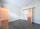 Bedroom with gray wood-look tile floor and a large closet at 1065 Blackwolf Run Rd, Davenport, FL 33896