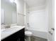 Clean bathroom with white tile, bathtub, and dark vanity at 1065 Blackwolf Run Rd, Davenport, FL 33896