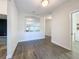 Bright dining room with wood-look tile floors and view into the living area at 1065 Blackwolf Run Rd, Davenport, FL 33896