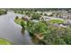 Aerial view of townhouses near a lake, showcasing the community's waterfront location at 210 Majors Ln # B, Kissimmee, FL 34743