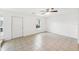 Spacious living area with tile floors, a window, and a door at 210 Majors Ln # B, Kissimmee, FL 34743