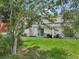 Spacious backyard with a grassy area and mature trees at 210 Majors Ln # B, Kissimmee, FL 34743