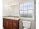 Bathroom with vanity, toilet and window at 210 Majors Ln # B, Kissimmee, FL 34743
