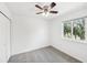 Bedroom with grey carpet, ceiling fan and window at 210 Majors Ln # B, Kissimmee, FL 34743