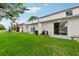 Backyard with grass, patio, and lake view at 210 Majors Ln # B, Kissimmee, FL 34743