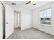 Bedroom with grey carpet, ceiling fan and window at 210 Majors Ln # B, Kissimmee, FL 34743