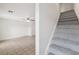 Interior stairs with grey carpet leading to the second floor at 210 Majors Ln # B, Kissimmee, FL 34743