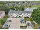 Aerial view showing three-unit building and lake at 210 Majors Ln # B, Kissimmee, FL 34743