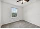 Bedroom with grey carpet, ceiling fan and window at 210 Majors Ln # B, Kissimmee, FL 34743