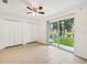 Bedroom with tile floors, ceiling fan, and sliding glass doors leading to backyard at 210 Majors Ln # B, Kissimmee, FL 34743