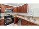 Kitchen with stainless steel appliances and dark wood cabinets at 210 Majors Ln # B, Kissimmee, FL 34743