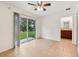 Bright bedroom with tile floors, a ceiling fan and sliding glass doors at 210 Majors Ln # B, Kissimmee, FL 34743