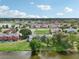 Aerial view of townhouses and lake, highlighting the community's serene setting at 210 Majors Ln # B, Kissimmee, FL 34743