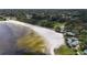Aerial view of a sandy beach with volleyball court and playground at 1700 Minnesota Ave, St Cloud, FL 34769