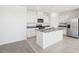 Modern kitchen with white cabinets, granite countertops and island at 519 Kennedy Dr, Lake Alfred, FL 33850