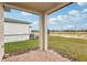 Covered patio with brick pavers and backyard view at 523 Kennedy Dr, Lake Alfred, FL 33850