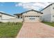Single-Gathering home with a brick driveway at 523 Kennedy Dr, Lake Alfred, FL 33850