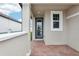 Brick paved back patio with access door and a view of the backyard at 523 Kennedy Dr, Lake Alfred, FL 33850