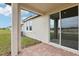 Covered patio with sliding glass doors and backyard view at 523 Kennedy Dr, Lake Alfred, FL 33850