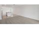 Spacious living room with grey carpet and an open floor plan at 523 Kennedy Dr, Lake Alfred, FL 33850