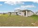 View of home's backyard and covered patio at 523 Kennedy Dr, Lake Alfred, FL 33850