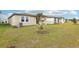 Backyard view of home with covered patio at 523 Kennedy Dr, Lake Alfred, FL 33850