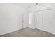 Bright bedroom with neutral carpeting and an open door at 523 Kennedy Dr, Lake Alfred, FL 33850