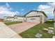 Single-Gathering home with landscaping and a brick driveway at 523 Kennedy Dr, Lake Alfred, FL 33850